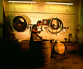 Cooper repairing a whisky cask
