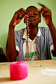 Making a necklace,Uganda