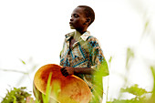Child with an empty gourd,Uganda