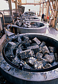Auto parts being dissolved in acid for recycling