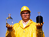 Worker holds treated and untreated sewage samples