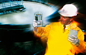 Worker holds treated and untreated water samples