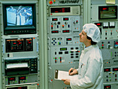 Worker & control panel in an optical fibre factory