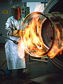 Glass technician manufacturing a large glass tube