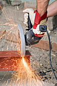 Worker cutting metal