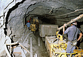 Removing debris by silver mine workers