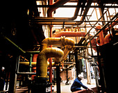 Pipes & worker at chlorine producing plant