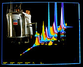 Chemist with NMR spectrometer & display
