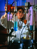 Chemist using glassware in a laboratory