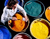 Worker with batches of ceramic pigments