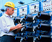 Technician with machinery for making carbon fibres