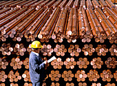 Technician inspects stored copper bars