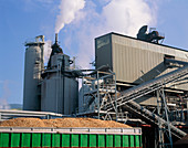 Container of wood chips outside a paper mill