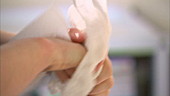 Nurse drying her hands after washing