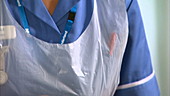 Nurse filling syringe with liquid