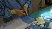 Doctor preparing surgical equipment