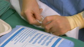 Doctor attaching bag with plastic clips