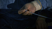 Dr preparing tube in operating theatre