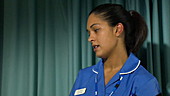 Nurse talking to patient in hospital bed