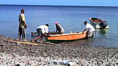 Men launching canoe