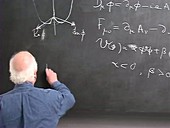Peter Higgs signing his equations