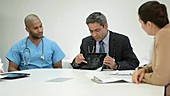 Four doctors using digital tablet