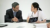 Two doctors using digital tablet