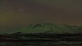 Aurora borealis over mountains, timelapse