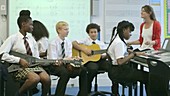 School children learning music