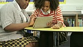 Schoolgirls using tablet