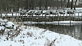 Boats by lake in winter