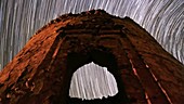 Star trails over ruined tower