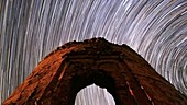 Star trails over ruined tower