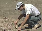 Archaeologist using trowel