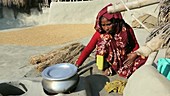 Woman cooking with clay oven