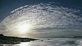 Moonset and daybreak over sea