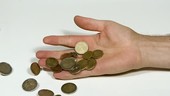 Euro coins falling from hand