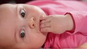 Baby chewing hand