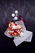 Peach and strawberry ice cream in waffles with fresh and freeze-dried strawberries and meringue