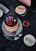 Chocolate cake with chocolate cream, frozen blackberries and cranberries