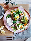 Pea, zucchini and mint fritters with eggs and feta sauce