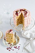 Rose and lemon layer cake, sliced, decorated with rose petals
