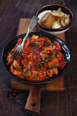 Braised pork with peppers and tomatoes