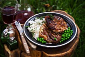 Grilled pork collar steak with rice and peas