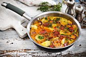 Omelette with potatoes and sausage in a pan