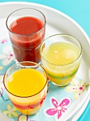 Three glasses of juice on a summer tray