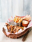 Peri peri chicken with fries and coleslaw served in a basket