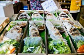 Fish in a salt crust with salad and sauce at a market in Thailand