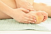 A woman massaging her feet