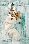 Cinnamon stars, nuts and anise starts in a Christmas stocking